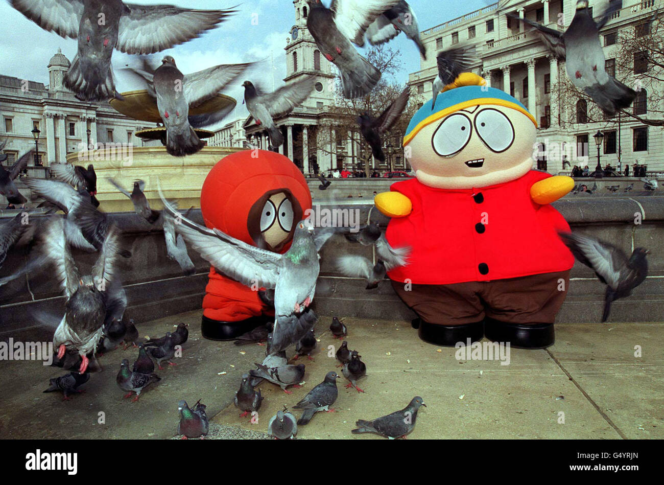 Kenny (left) and Cartman, characters from the South Park cartoon television  show, feed the pigeons in Trafalgar Square, during their tour around London  to launch the video and DVD release of 'South