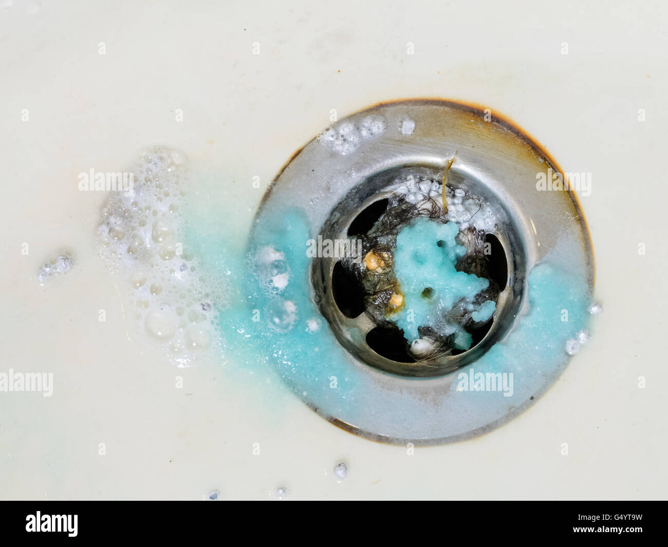 Cleaning bath plug hole with washing crystal chemicals Stock Photo Alamy