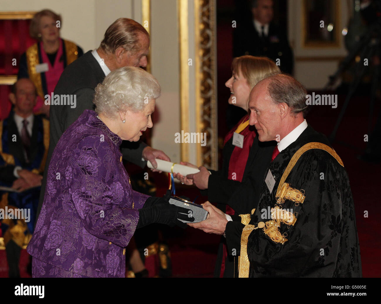 Queen Elizabeth II and The Duke of Edinburgh present a Royal Anniversary Prize for Higher and Further Education to Professor David Greenaway and Professor Katherine Smart of the University of Nottingham, at Buckingham Palace, central London. Stock Photo