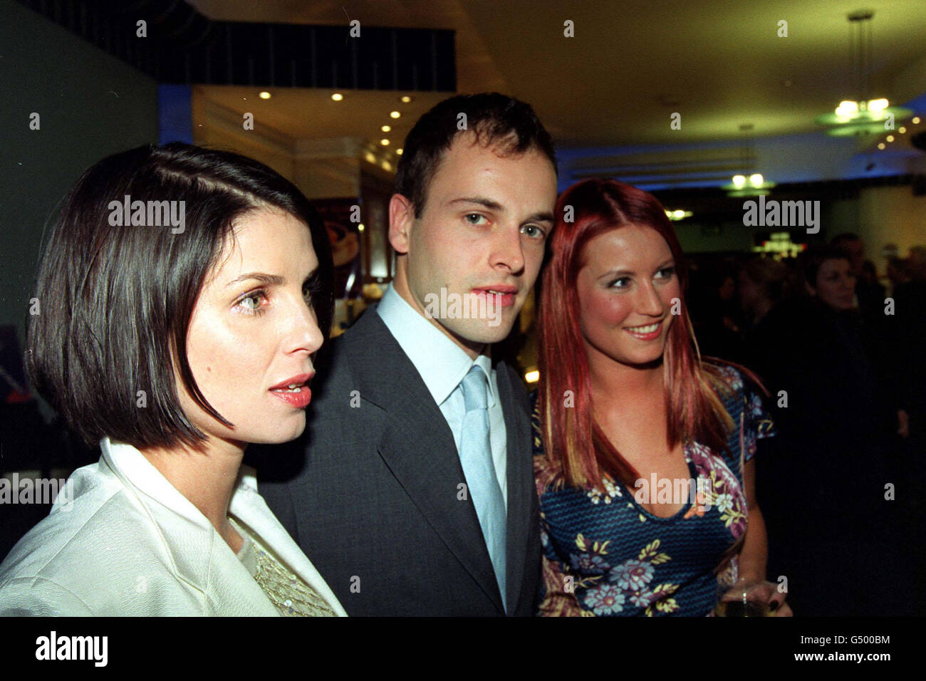 Actresses Sadie Frost (L) and Denise van Outen (R), who star in the film, with actor Johnny Lee Miller arriving for the world premiere of 'Love, Honour & Obey', at the Camden Odeon cinema in west London. Stock Photo