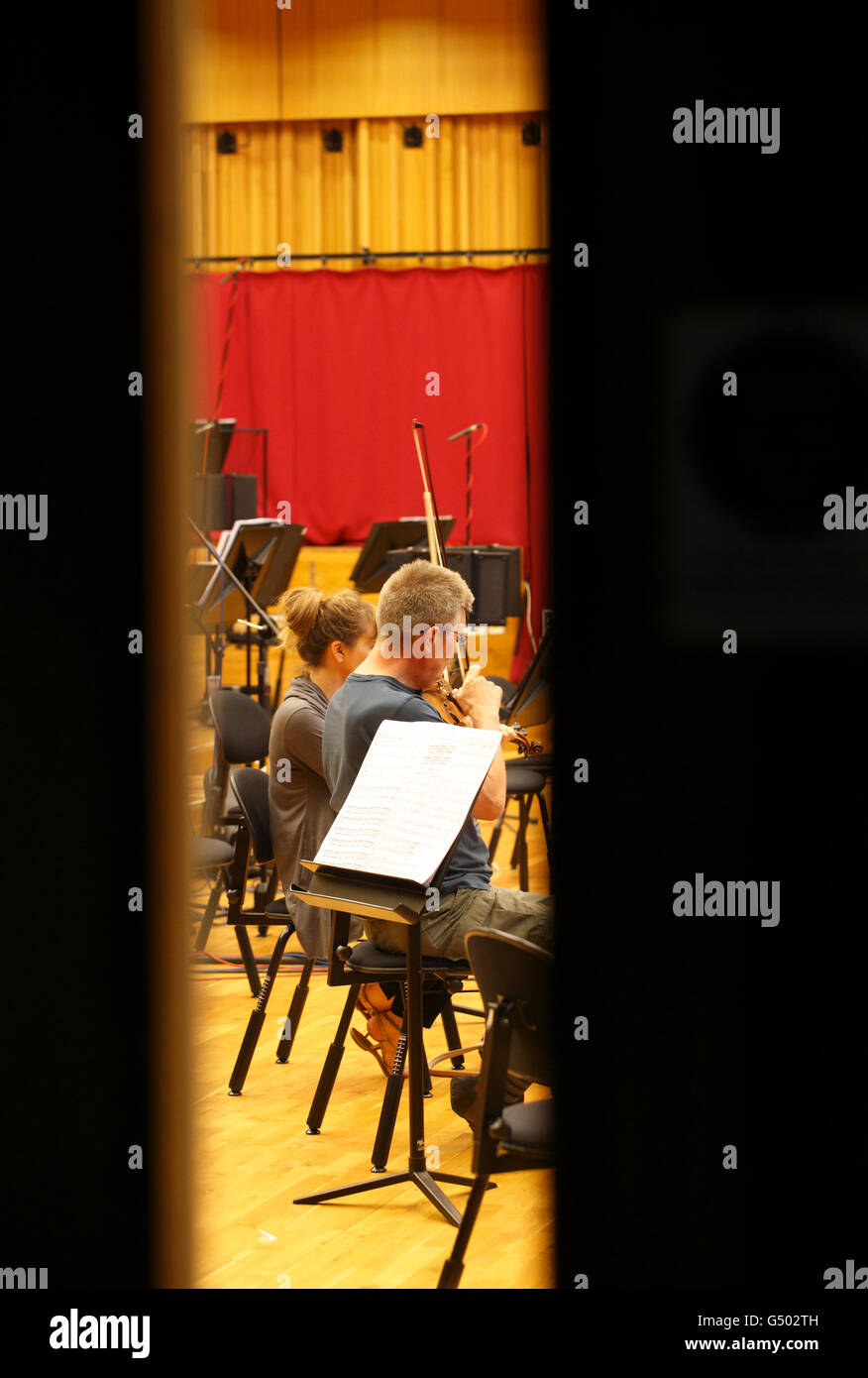 studio recording musicians in a live recording studio recording music. Violinists. Stock Photo
