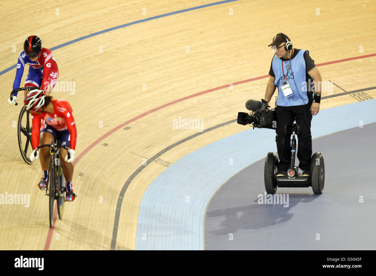 A television cameraman (right) captures the action between Great Britain's Victoria Pendleton (left) and Hong Kong's Wei Sze Lee, as he rides a Segway Stock Photo