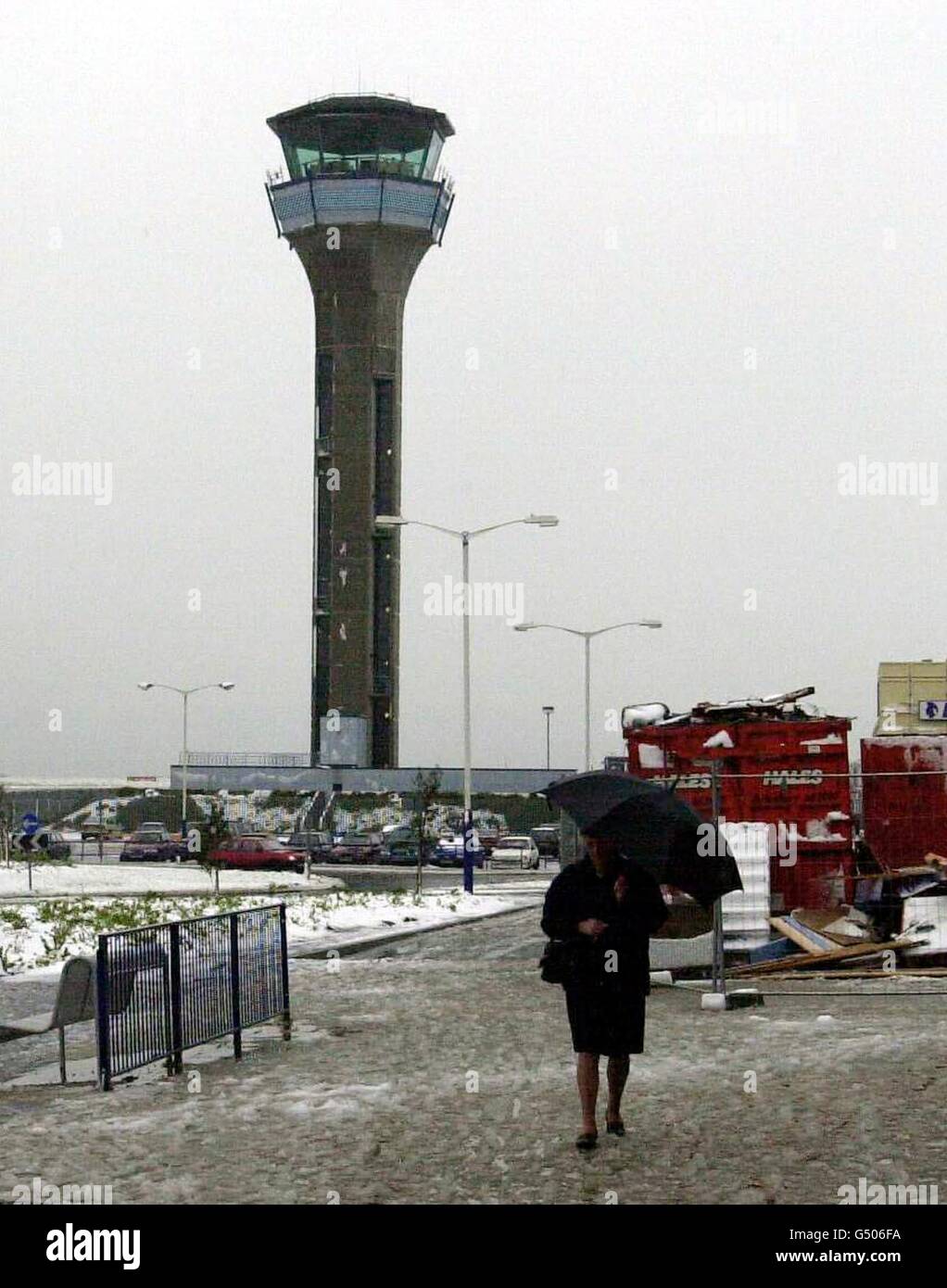 A passenger walks through slush to the terminal at Luton Airport, where twenty planes had to be diverted overnight when heavy snow closed the airport. Passenger and cargo planes were diverted to Birmingham and Stansted from 9.30pm last night. * ...until it reopened at around breakfast time. Stock Photo