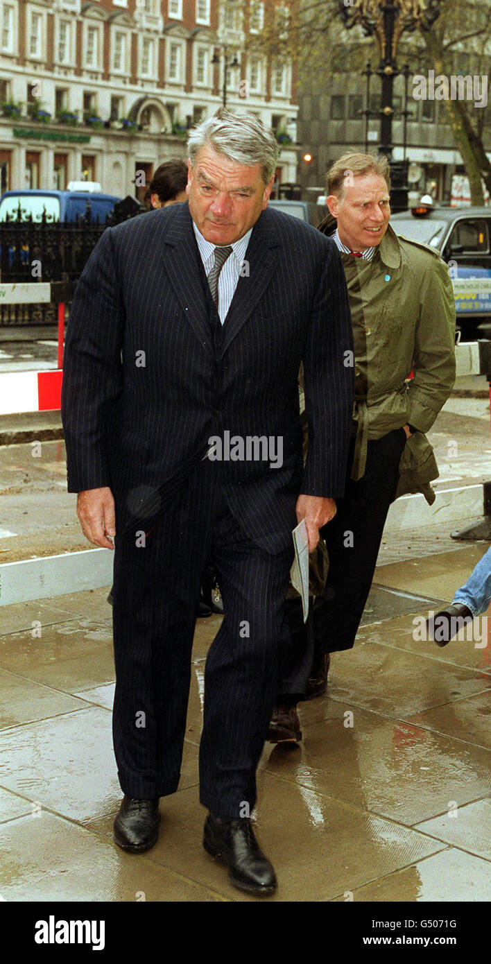 Historian David Irving (L) dodges eggs thrown at him before arriving at the High Court in London, to hear the verdict of his libel trial against American academic Deborah Lipstadt and publishers Penguin. * Mr Justice Gray rejected his libel action over her 1994 book Denying the Holocaust: The Growing Assault on Truth and Memory. Irving claimed the book had destroyed his livelihood and generated waves of hatred against him. Stock Photo