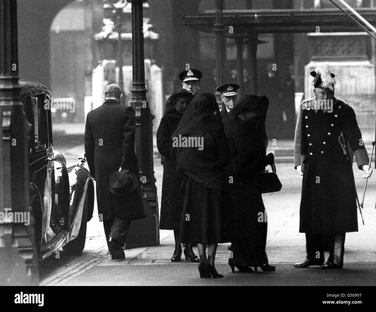 Members of the Royal Family arrive at Westminster Hall, London, before the funeral procession of King George VI: The Princess Elizabeth (later Queen Elizabeth II) (back to camera), Queen Elizabeth (later the Queen Mother) (right), The Duke of Windsor (behind Queen Mother), Earl Mountbatten (next to Duke), and the Earl Marshall (Duke of Norfolk). Stock Photo