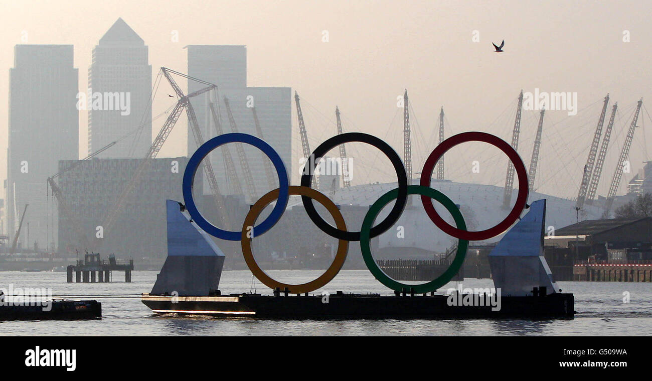 Giant olympic rings pass canary wharf and the o2 arena hi-res stock ...