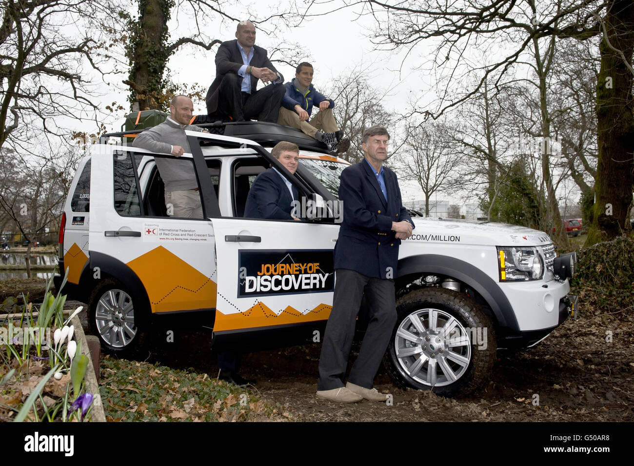 Polar explorer Ben Saunders (left), Monty Halls (second left), Ray Mears, (bottom centre), Bear Grylls (top centre) and Sir Ranaulph Fiennes gather around the 1,000,000th Land Rover Discovery in the off road track at the Jaguar Land Rover factory in Solihull. Stock Photo