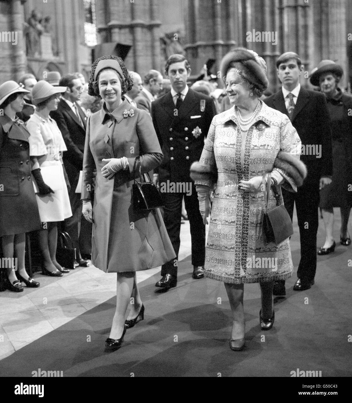 The Queen's Procession, shortly after arrival at Westminster Abbey for the Royal Wedding of Princess Anneand Captain Mark Phillips. The Queen (left) walks alongside The Queen Mother. Behind them, the uniformed Prince of Wales and his brother, Prince Andrew. Stock Photo