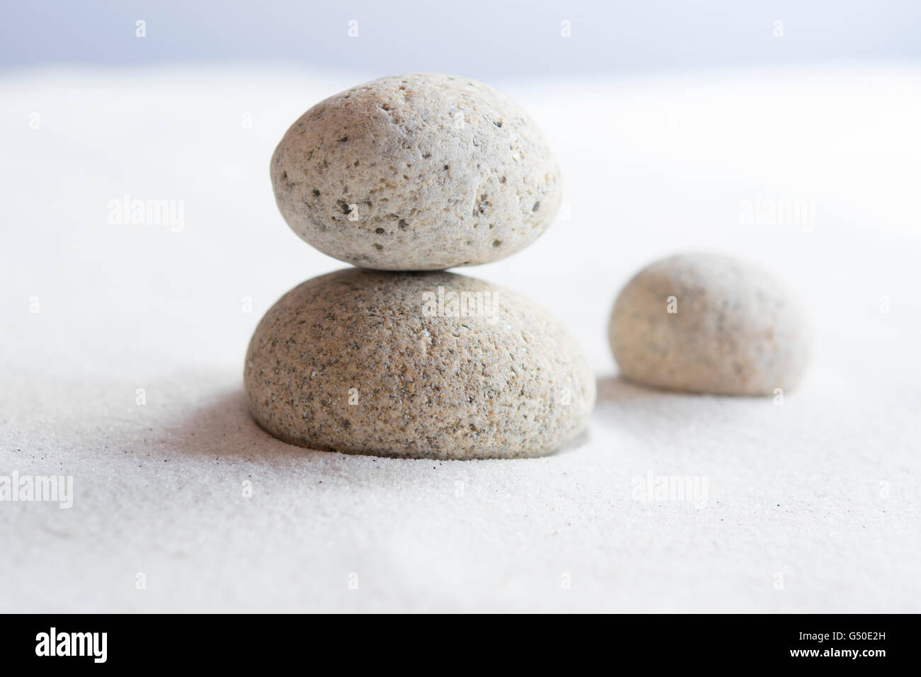 Meditative stones on white sand Stock Photo