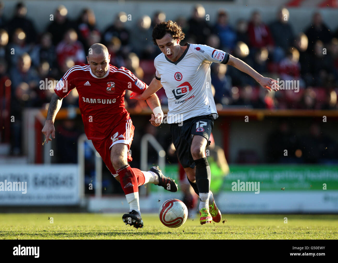 Swindon Town's Alan McCormack (left) battles for possession of the ball with Accrington Stanley's Jamie Devitt during the npower League Two match at The County Ground, Swindon. Stock Photo
