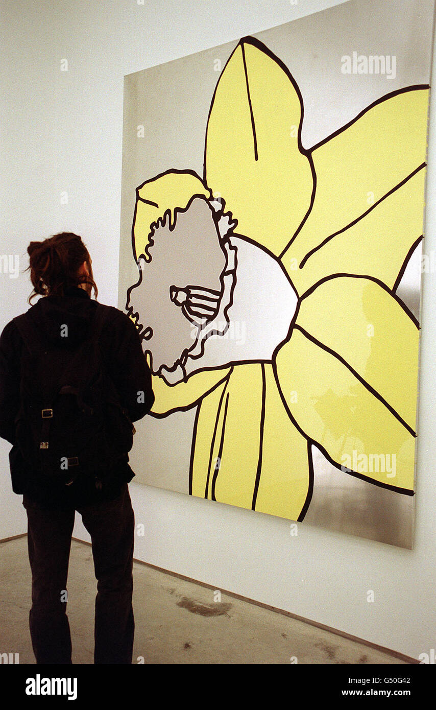 A member of the public views Daffodils by artist Gary Hume, an enamel painting on an aluminium panel, which features alongside works by Damien Hirst and the Chapman brothers, for the first exhibition at the new White Cube 2 gallery in Hoxton Square, London. * which is the latest venture for renowned art dealer Jay Jopling. Stock Photo