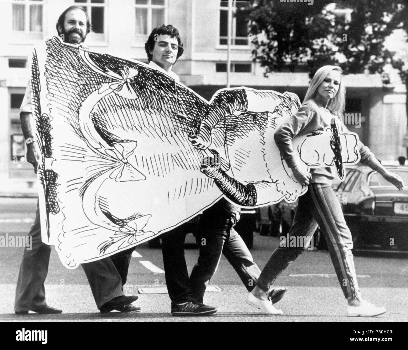 (l/r) John Cleese, Rowan Atkinson, David Rappaport ( hidden) and Pamela Stephenson, carrying a cardboard cut out during rehearsals at the Theatre Royal in Drury Lane for the show, 'The Secret Policeman's Other Ball.' The gala is in aid of Amnesty International. Stock Photo