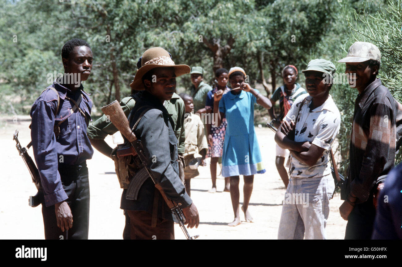 RHODESIA 1980: Armed members of the ZANLA patriotic front and their womenfolk at a ceasefire assemby point called Foxtrot, 130 miles SW of Salisbury (now Harare), where they are waiting in a camp run by British troops before the Rhodesian General Election. Stock Photo