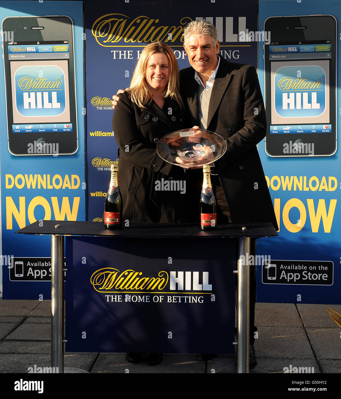 A representative of the owners of Grumeti is presented with a trophy after victory in the williamhill.com Dovecote Novices' Hurdle Stock Photo