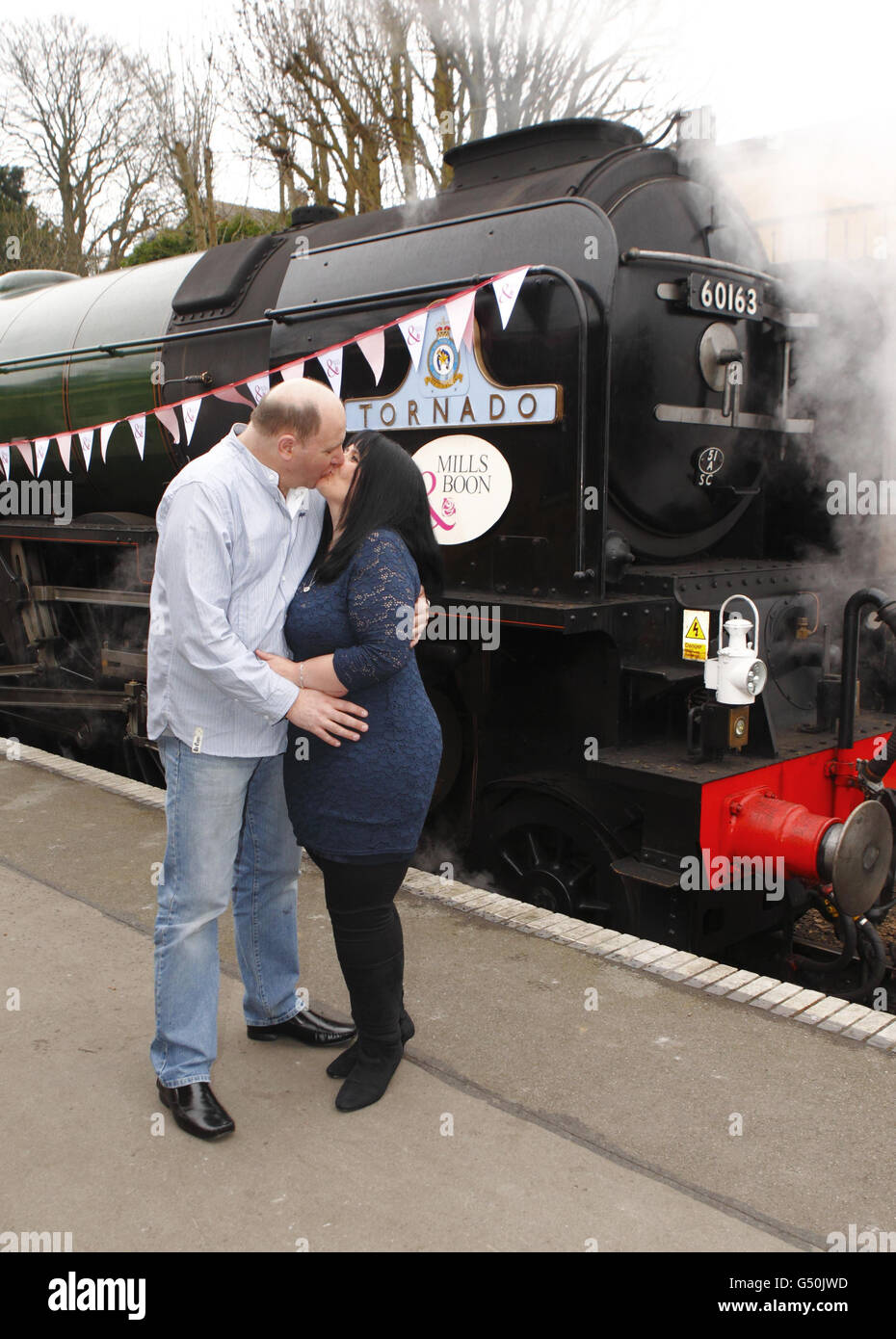 Fiona Boubert kisses her partner Neil Kennedy after she proposed to him on the Watercress Line steam railway at Alresford near Winchester, Hampshire. Stock Photo