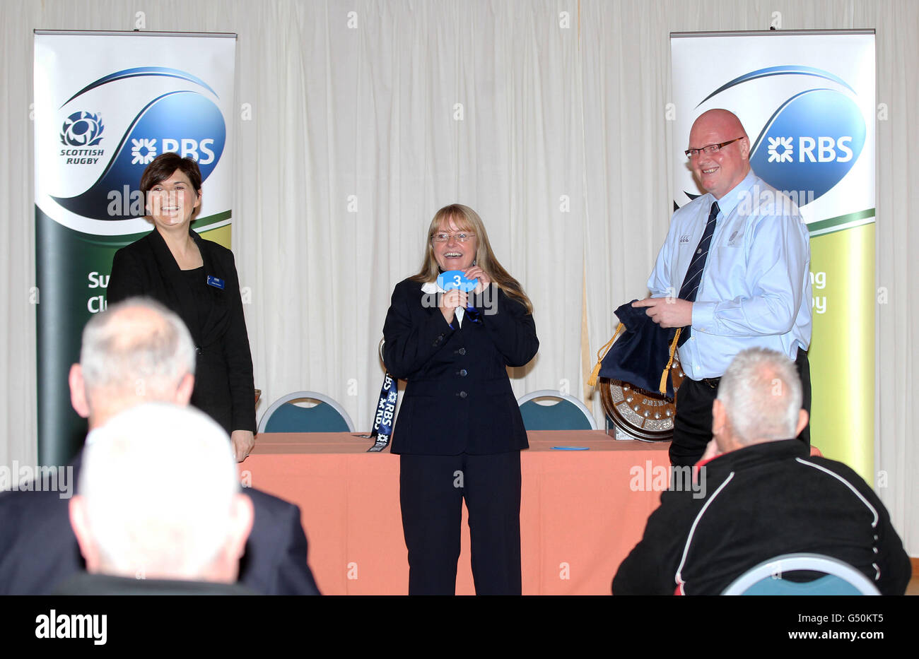 RBS's representatives Hazel Anderson (left) and Louise Buchanan (centre) make the draw with SRU Competitions Administrator Neil Crooks during the launch of the RBS National Cup, Shield and Bowl at Dunbar RFC, Dunbar. Stock Photo