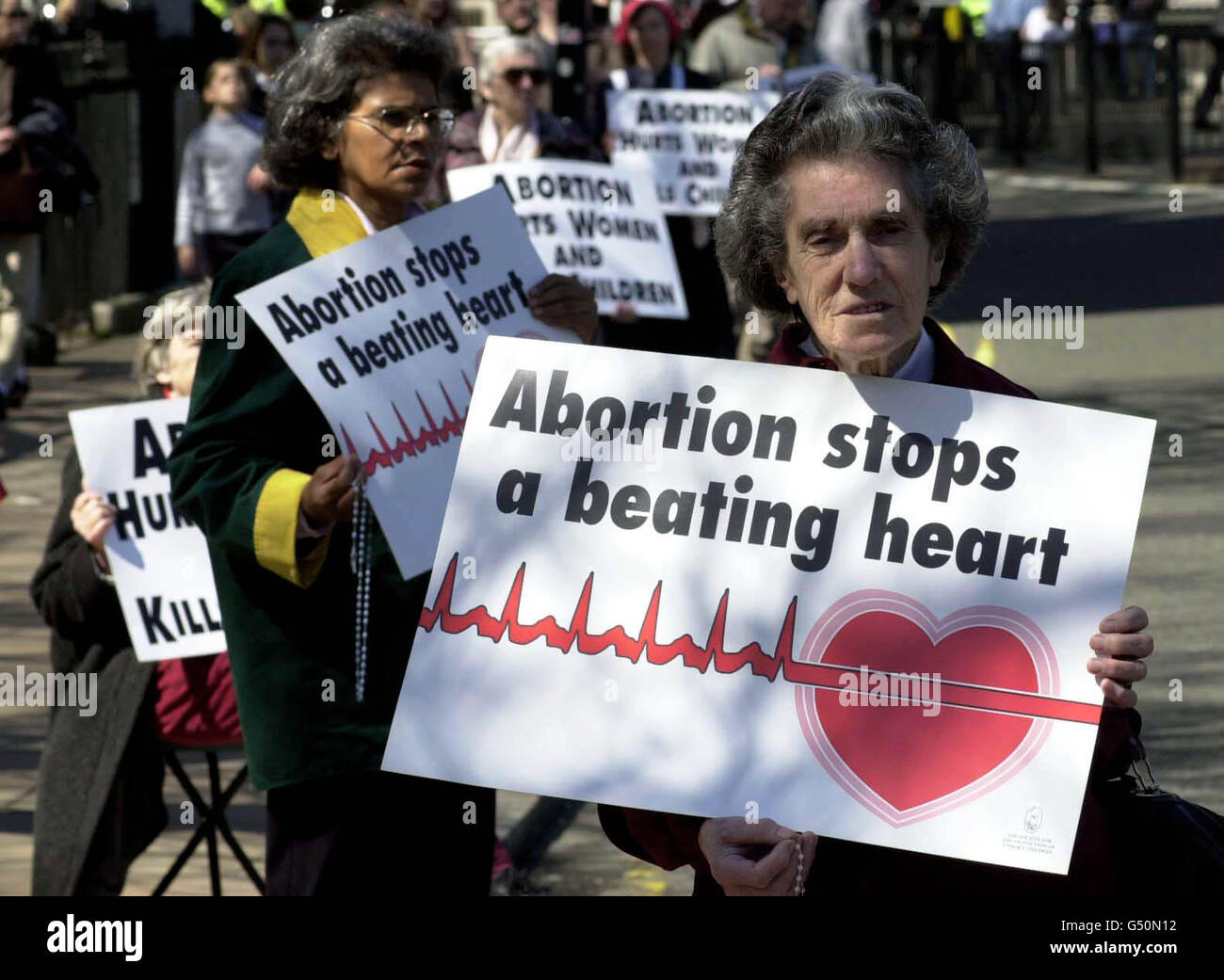 Anti-abortion campaigners from The Society for the Protection of Unborn Children hold aloft placards outside the Houses of Parliament. Protesters were forming human chains in 84 cities and towns across the UK to protest against the Abortion act. Stock Photo