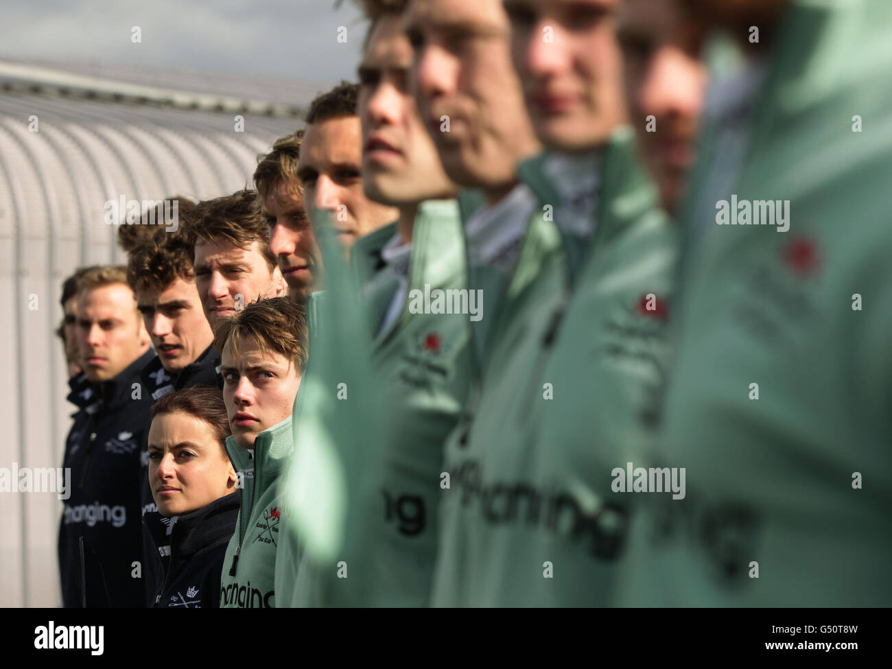 The coxes for Oxford, Zoe De Toledo and Cambridge, Ed Bosson pose with their teams following the weigh in for the 158th Boat Race, in front of the Olympic Stadium on the roof of Formans Fish Island, in London. Stock Photo