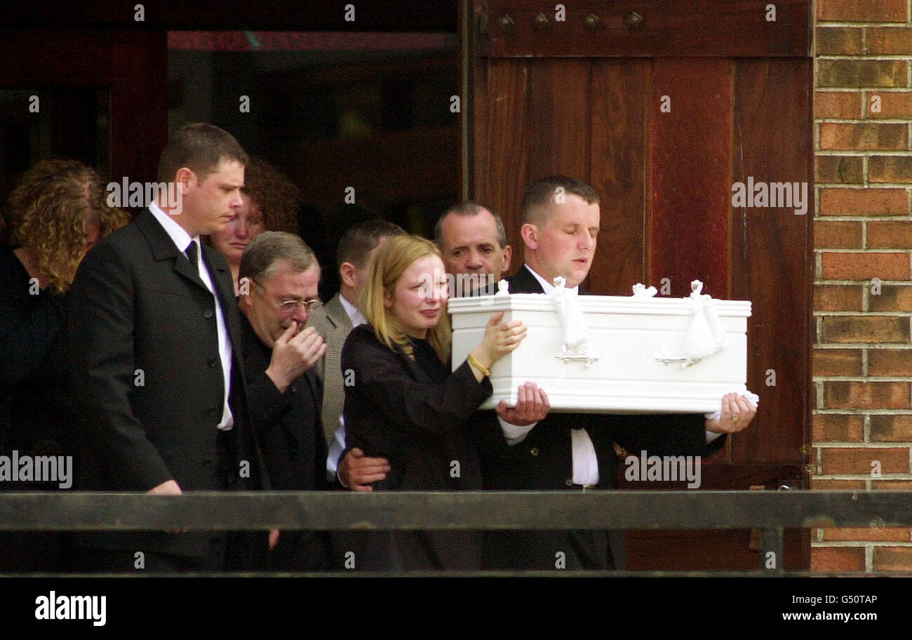 Father Craig Millar, 28 and mother Mary Millar, 27, carry the coffin at the Holy Family church in Port Glasgow, Scotland, of their six month old son Robbie Millar. The baby was allegedly killed when the car carrying his family was forced off the motorway. Stock Photo