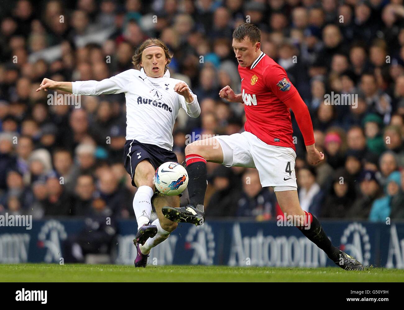 Tottenham Hotspur's Luka Modric (left) and Manchester United's Phil Jones battle for the ball Stock Photo