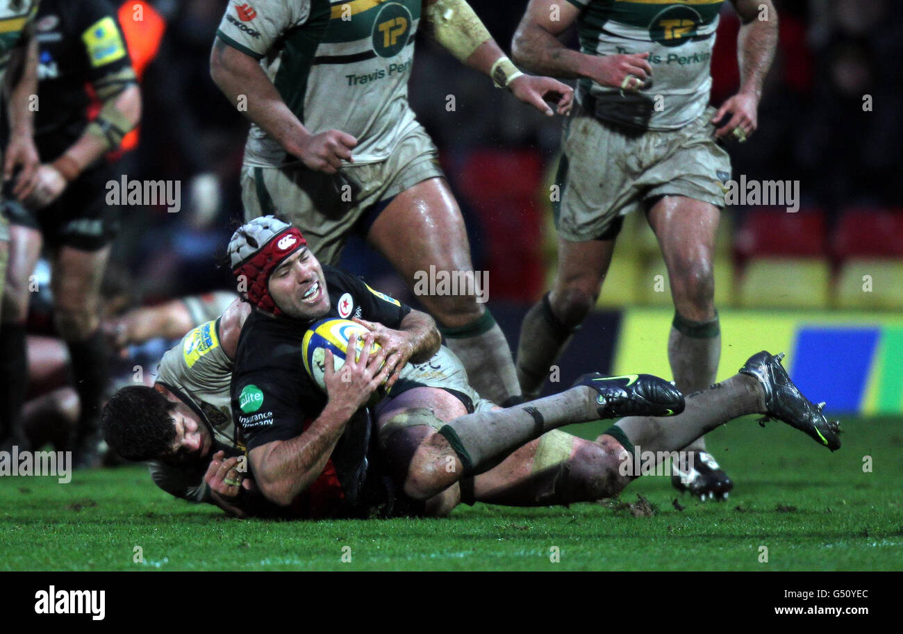 Saracens Schalk Brits is held by Northampton's Phil Dowson during the Aviva Premiership match at Vicarage Road, Watford. Stock Photo