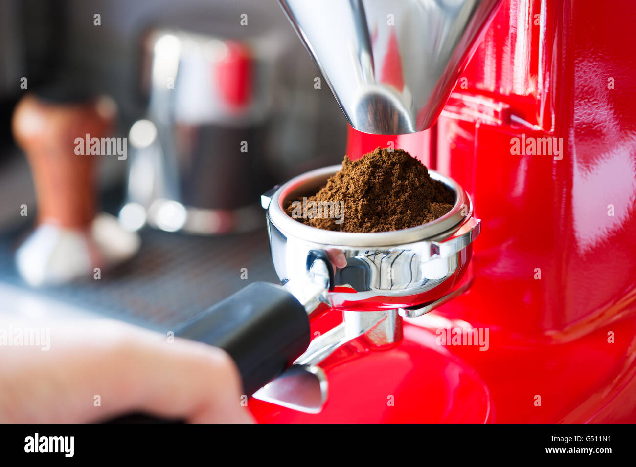 Coffee grinder grinding freshly roasted coffee beans Stock Photo Alamy