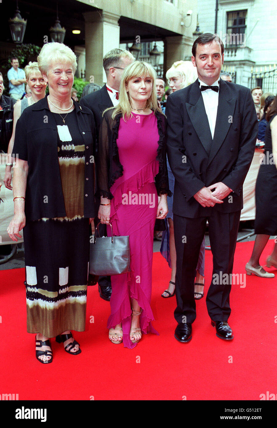 Actress and writer Caroline Aherne (centre) with her mother Maureen, and actor Craig Cash, from television's The Royle Family, arrive at the British Academy TV Awards (BAFTA's) in London. Stock Photo