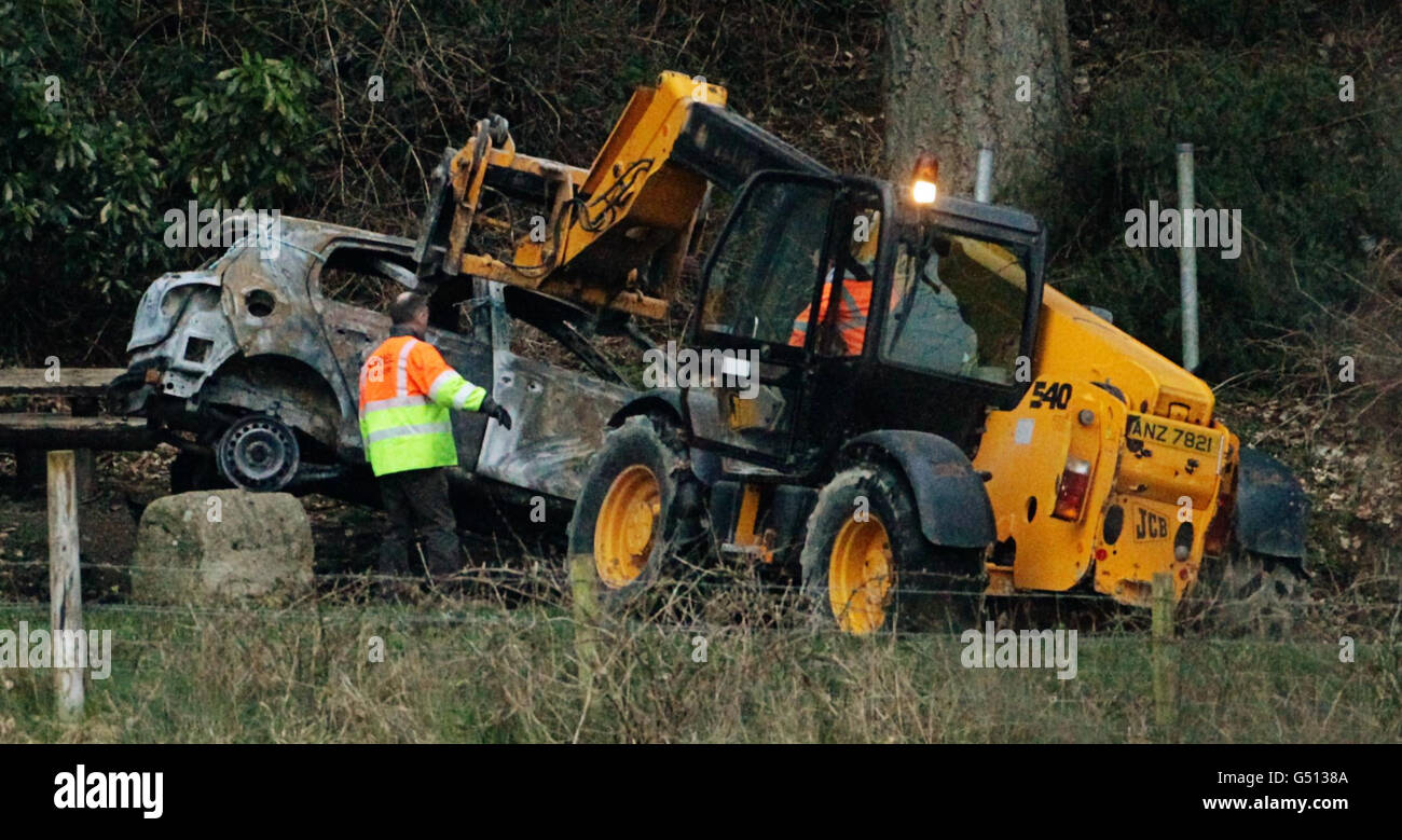 A burnt out car is removed from the scene at Ravensdale Park near Dundalk, in which two bodies were found. Stock Photo