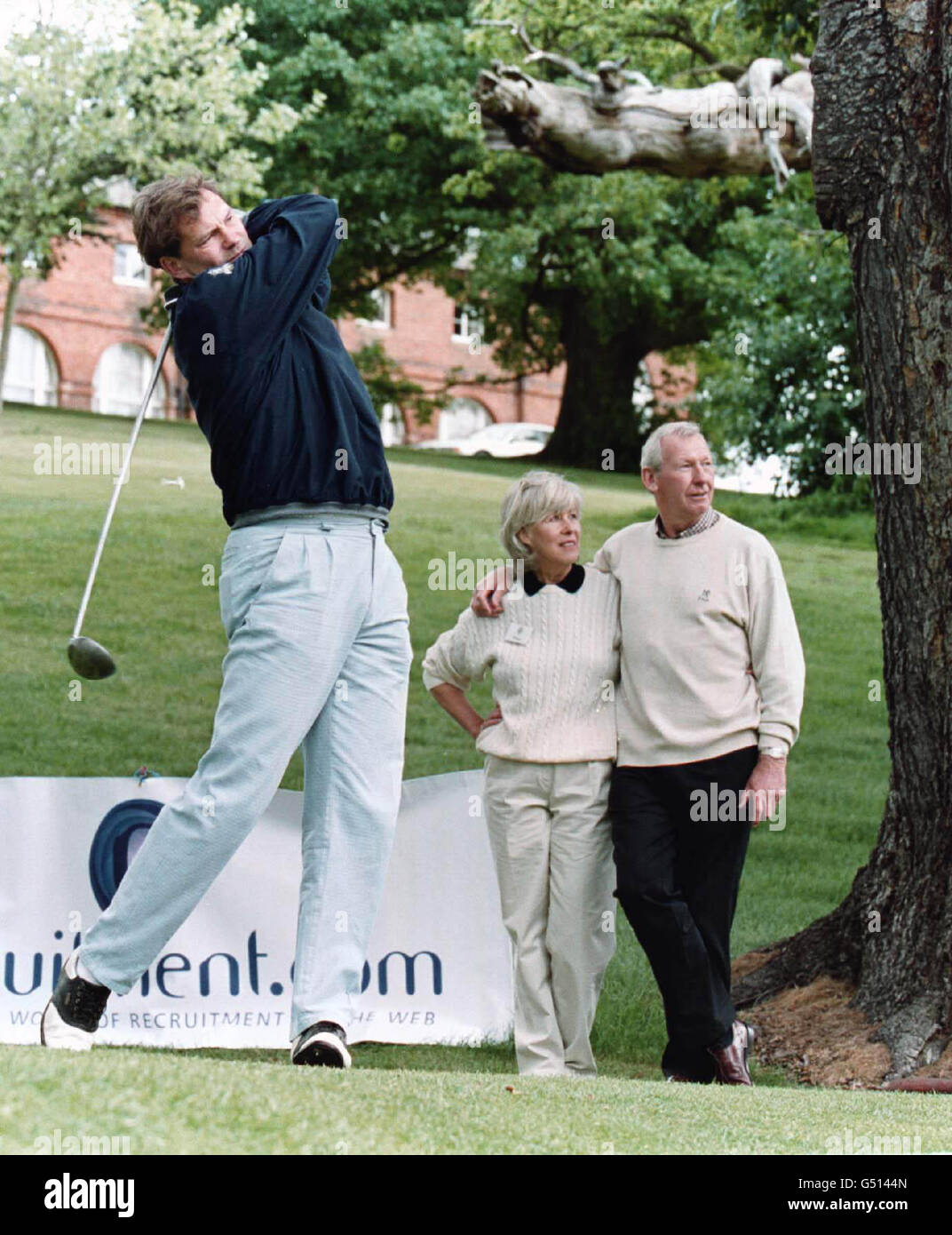 Former England manager Glenn Hoddle tees off, watched by Megs and Bob Wilson (background left & right), at a celebrity-am golf tournament at Brocket Hall, Hertfordshire, in aid of the Willow Foundation. * The Foundation is a charity set up by television football presenter Bob and his wife Megs in memory of their daughter Anna who died sixteen months ago. Stock Photo