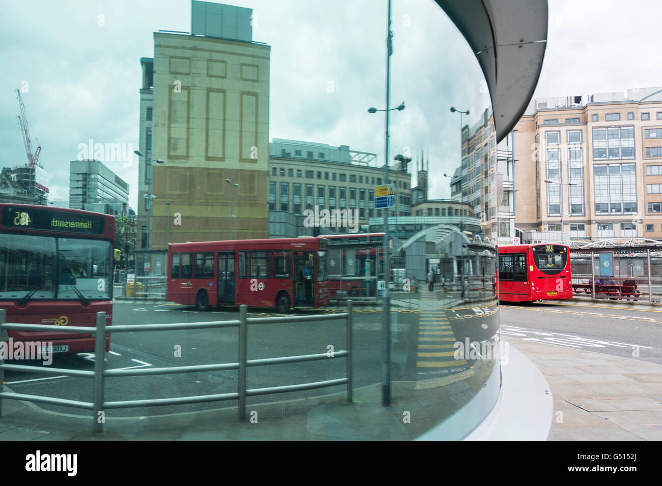 Reflections in a window at Hammersmith Bus Station, London, UK Stock