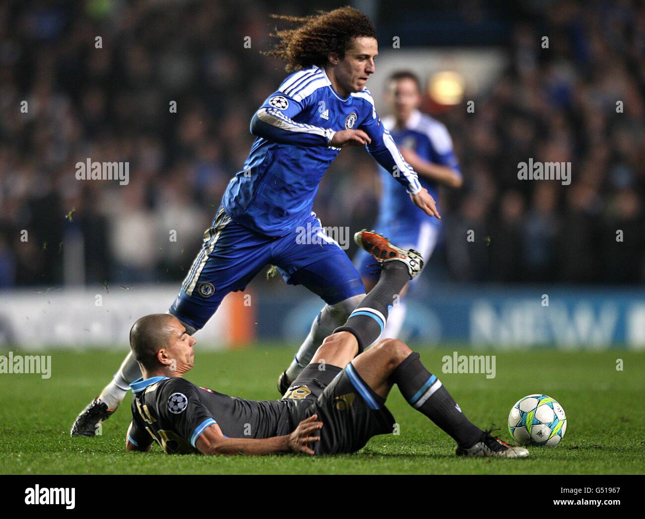 Napoli's Gokhan Inler takes a tumble after a challenge from Chelsea's David Luiz Stock Photo