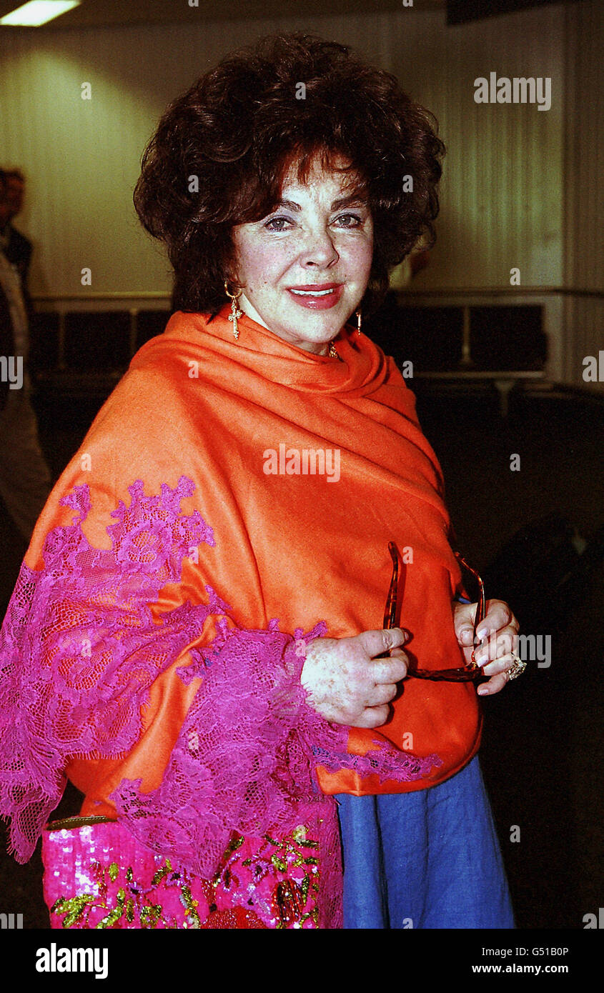 Hollywood actress Elizabeth Taylor arrives at Heathrow Airport from Los Angeles, as she prepares to be made a Dame by the Queen. The 68 year old British-born actress said she was thrilled to be receiving the honour and declared: 'It's the peak of my life'. Stock Photo