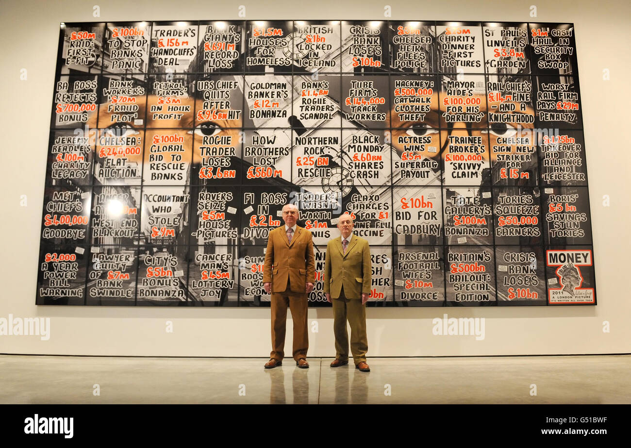 Artists Gilbert Proesch (right) and George Passmore (left) with artworks from their 'London Pictures' series, at White Cube gallery, in Bermondsey, London. Stock Photo