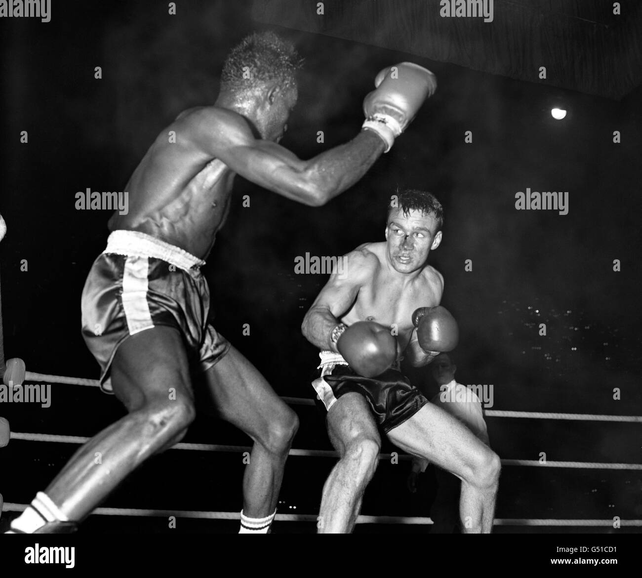 Britain's Dave Charnley (r) on the defensive as Joe Brown, from America, prepares to throw another punch. Joe Brown went on to win on points after 15 rounds. The fight was voted 1961 Ring Magazine Fight of the Year. Stock Photo