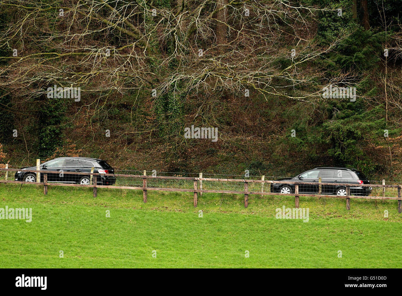 Bodies found in Ravensdale Park. Two Hearses leave the scene where two bodies were found in a burned out car at Ravensdale Park near Dundalk. Stock Photo
