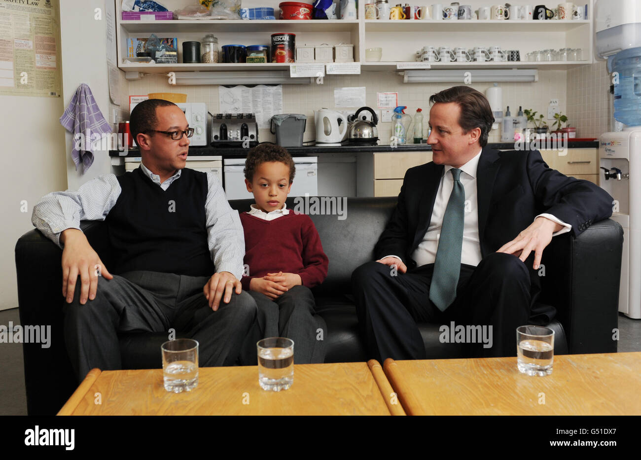 Prime Minister David Cameron meets Greg Edwards and his adopted son Daniel at South Acton Children's Centre in west London today where he discussed the current rules on adoption. Stock Photo