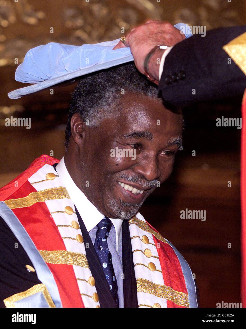 South African President Thabo Mbeki (L) is capped by the Glasgow Caledonian University at South Africa House in London May 19, after his conferment of an Honorary Doctorate. Stock Photo
