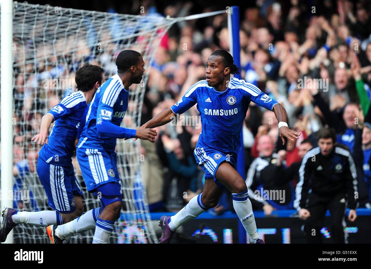 Chelsea's Didier Drogba (centre) celebrates scoring his side's first goal of the game with teammates Juan Mata (far left) and Daniel Sturridge Stock Photo