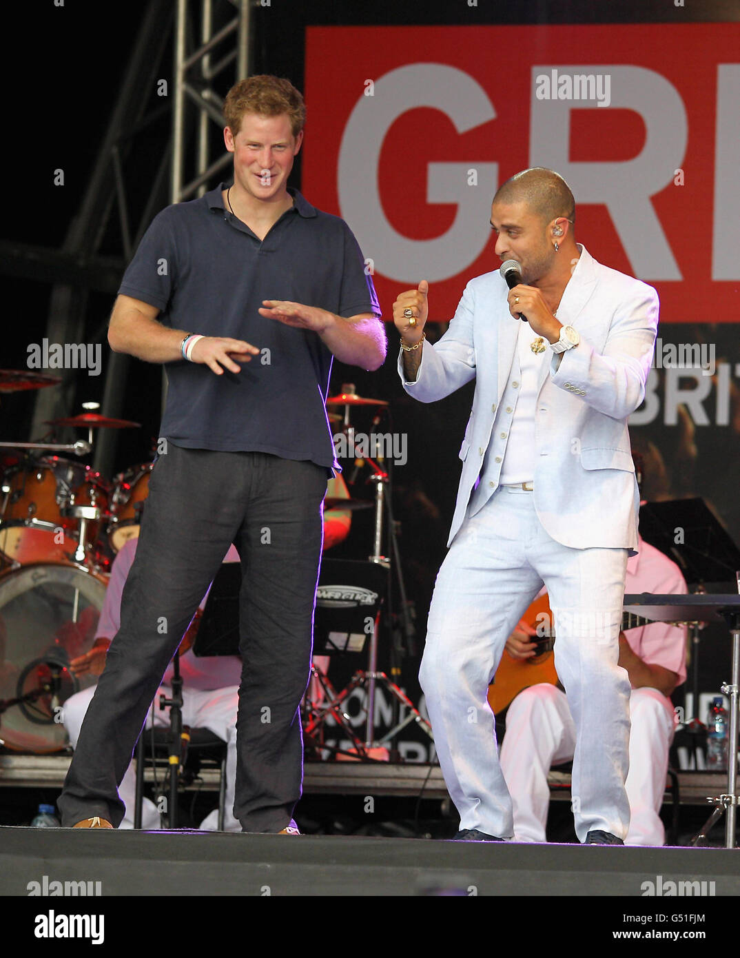 Prince Harry gets up on stage with Brazilian singer Diogo Nogueira during a GREAT event in the Favella of Complexo do Alemao in the northern suburb of Rio De Janeiro Brazil. Stock Photo
