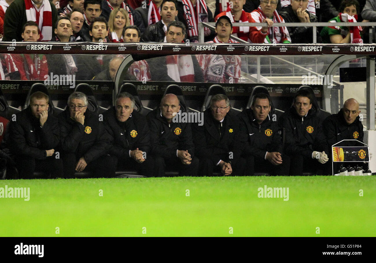 The Manchester United dugout with Paul Scholes (left), assistant manager Mick Phelan (fourth left), first team coach Rene Meulensteen (third right), goalkeeping coach Eric Steele (third left), head physiotherapist Rob Swire (right), kit manager Albert Morgan (second left) and manager Sir Alex Ferguson (fourth right). Stock Photo