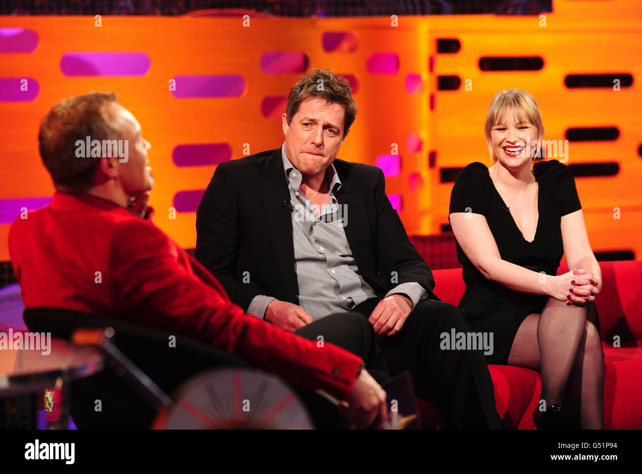 (Left - right) Graham Norton, Hugh Grant and Joanna Page during the filming of the Graham Norton Show at The London Studios, south London, to be aired on BBC One on Friday evening. PRESS ASSOCIATION Photo. Picture date: Thursday March 15, 2012. Photo credit should read: Ian West/PA Wire Stock Photo
