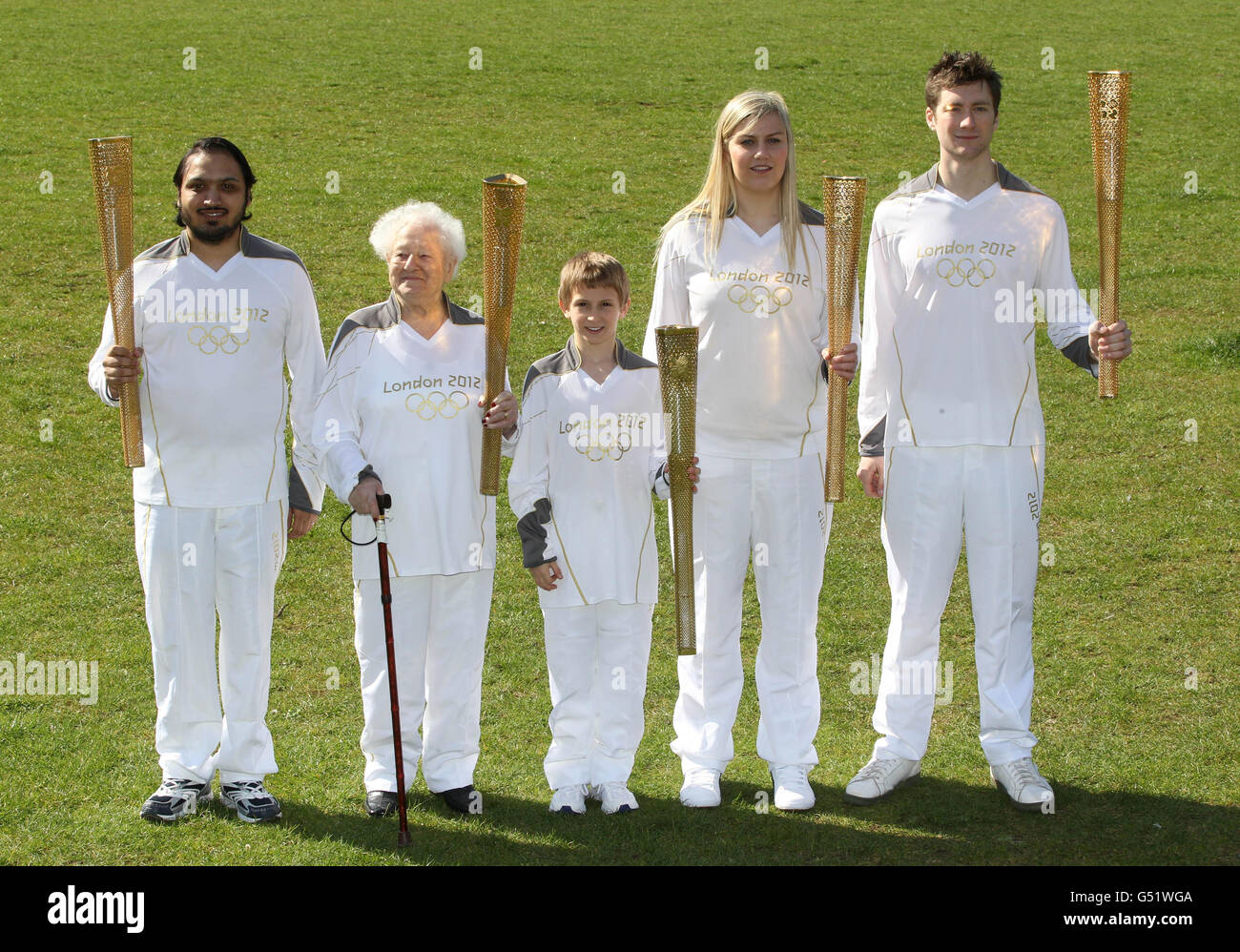 London 2012 Torchbearers (left to right) Abul Kasam aged 30, Dinah Gould aged 99, Dominic John MacGowan aged 11, Rosy Ryan aged 17 and Aidan Kirkwood aged 23 during a photocall at Redlands Primary School, London. Stock Photo