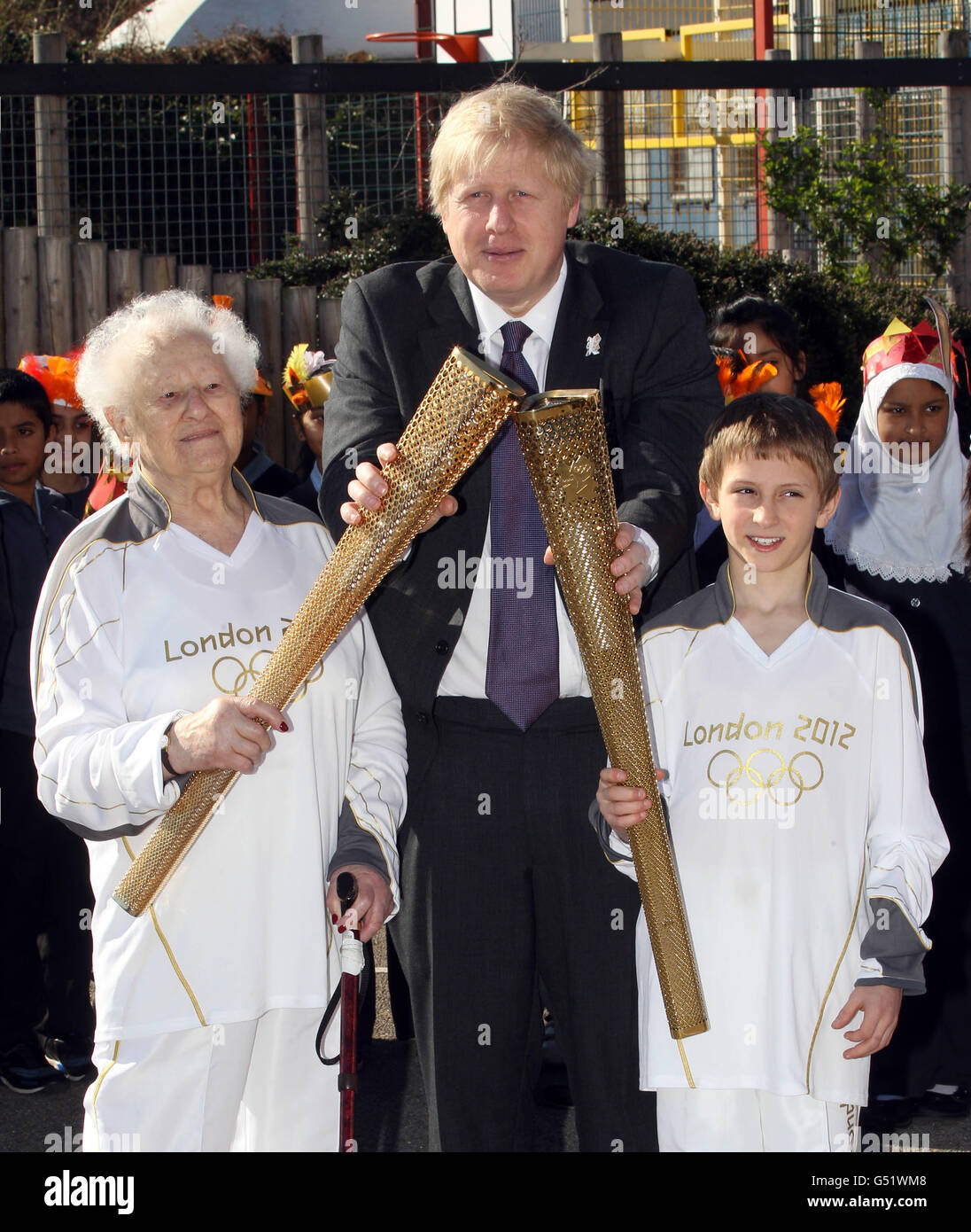 London 2012 Olympic Torchbearer's Dinah Gould aged 99 (left) and Dominic John MacGowan aged 11 (right) with London Mayor Boris Johnson during a photocall at Redlands Primary School, London. Stock Photo