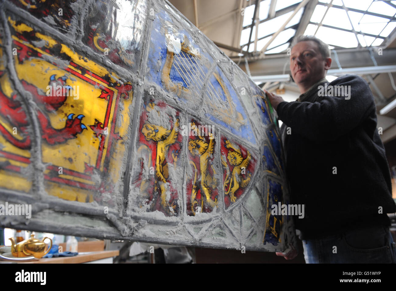 Artist John Reyntiens with the stained glass window he has designed for