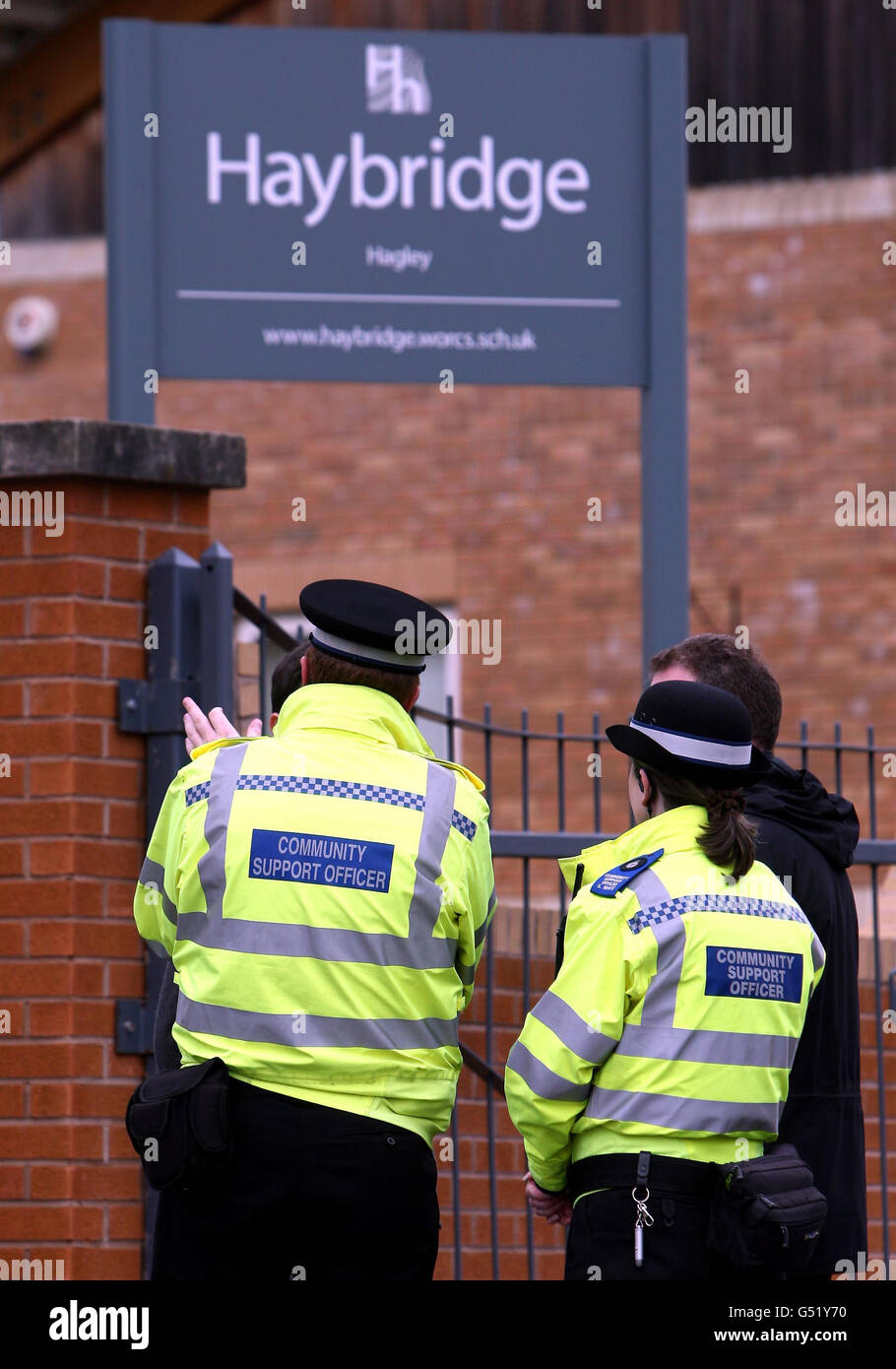 Community Police Officers and staff talk to visitors at the gates to