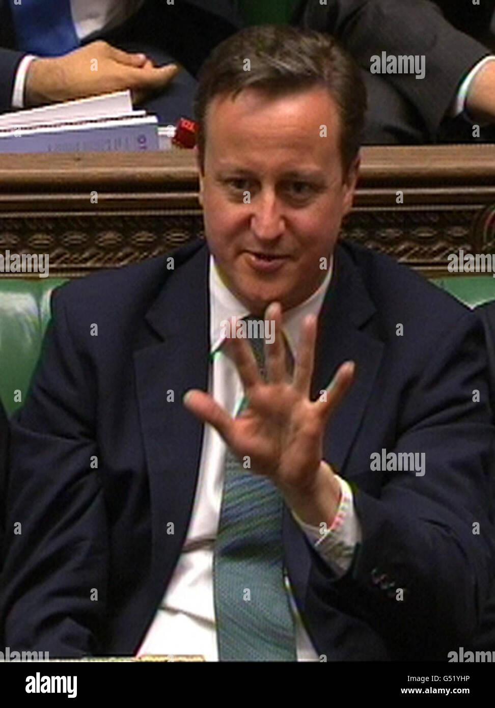 Prime Minister David Cameron gestures as Labour party leader Ed Miliband responds to the Budget statement in the House of Commons, London. Stock Photo