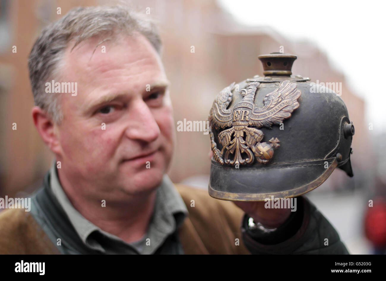 Ian Kidd holds a German army helmet as he attends the World War One Family History Roadshow at the National Library of Ireland in Dublin. Stock Photo