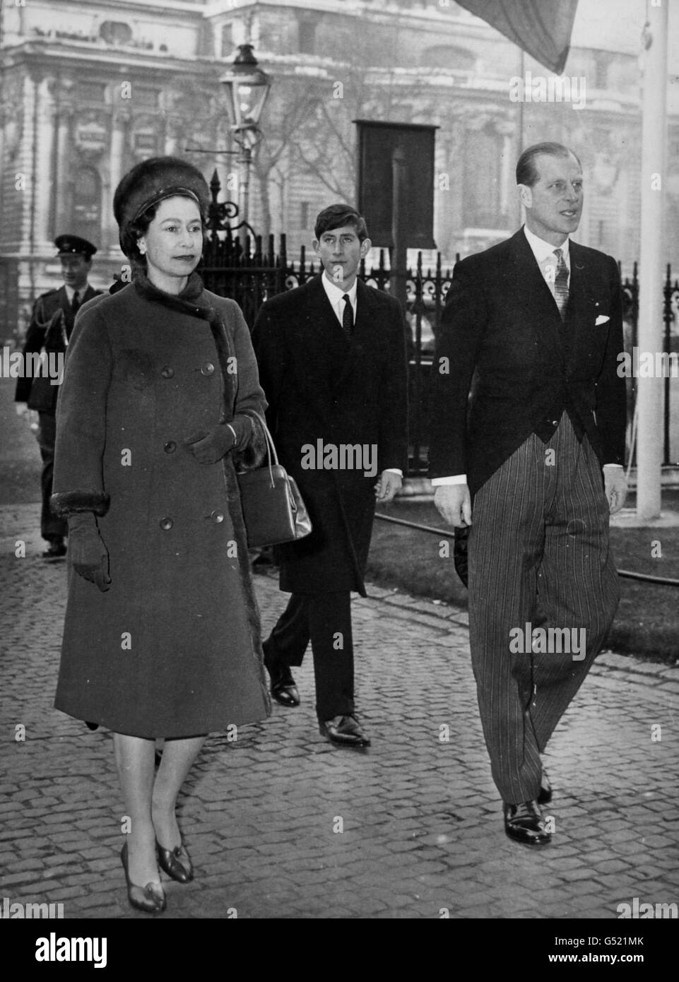 Queen Elizabeth II and the Duke of Edinburgh, followed by the Prince of Wales as they arrive at the West Door of Westminster Abbey, London to attend with other members of the Royal family a service marking the 900th anniversary of the consecration of the first Abbey church in 1065. Stock Photo