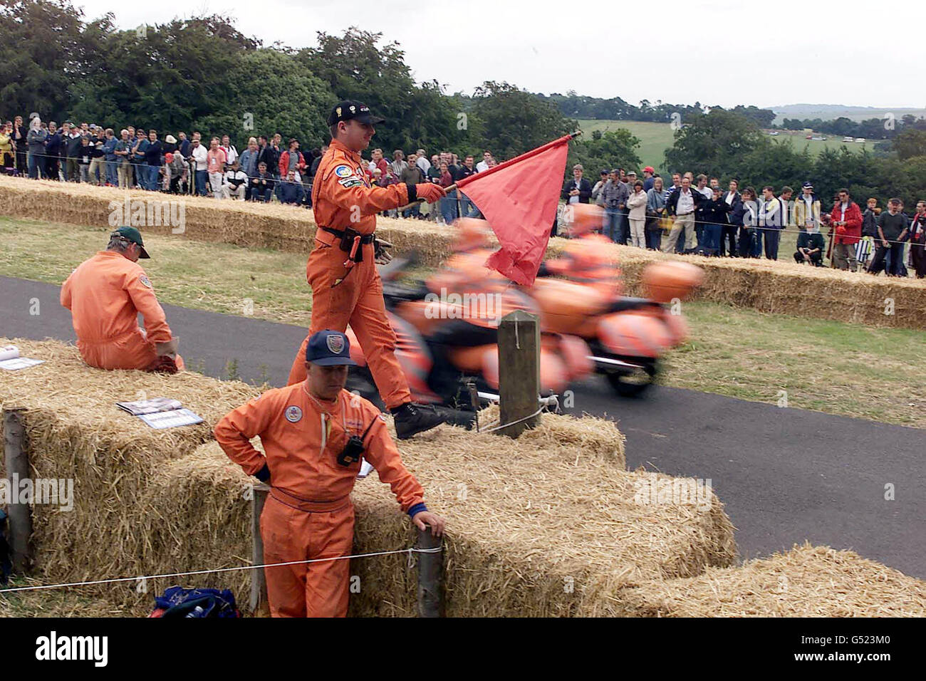 Track marshals watch the action near the finishing line at the Goodwood Festival of Speed in Sussex. Driver John Dawson-Damer crashed his 1969 Lotus Formula 1 car killing himself and a marshal as he crossed the line. * It is believed he lost control on the grass verge and struck a temporary gantry which has been removed. Mr Dawson-Damer's brother, The Earl of Portarlington paid tribute to his brother. Stock Photo