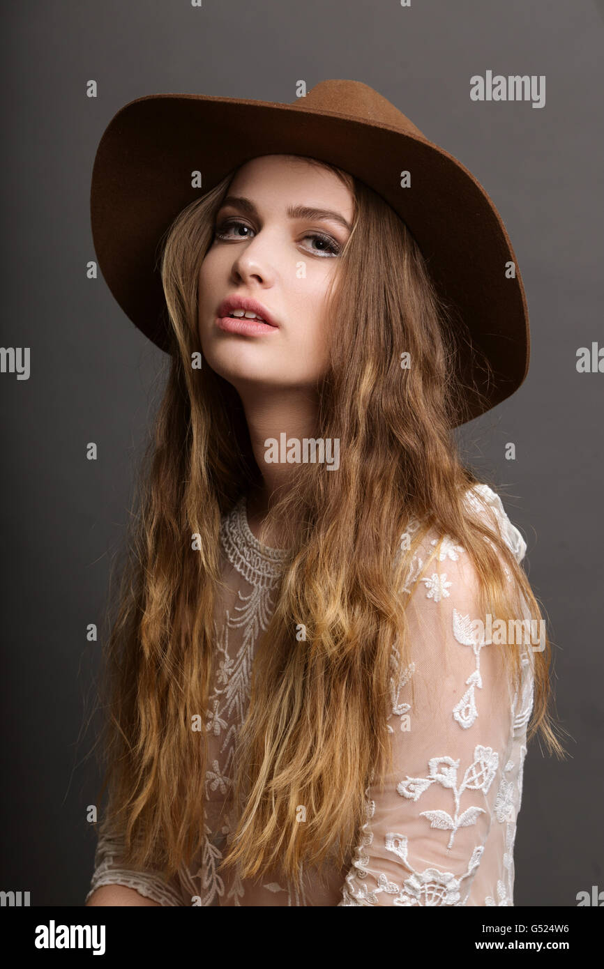 Fashion portrait of a beautiful girl wearing brown hat in studio Stock Photo Alamy